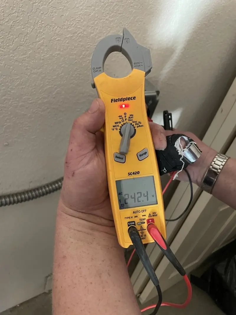Voltage testing with clamp meter during Electrical Installation Services in Owatonna